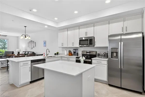 a kitchen with cabinets stainless steel appliances and sink