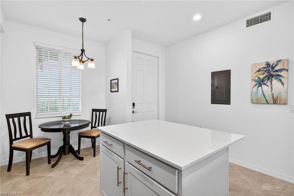 43985 Boardwalk Loop, Unit 2115 Punta Gorda, FL 33982 - Photo 3 of 28 a room with a table chairs and a window