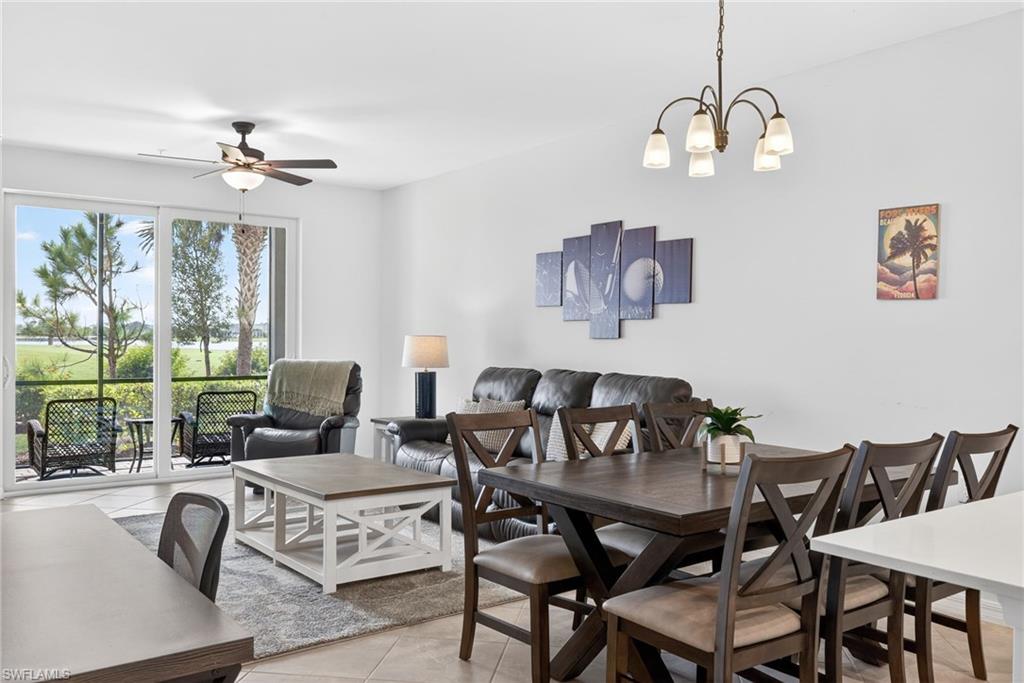 43985 Boardwalk Loop, Unit 2115 Punta Gorda, FL 33982 - Photo 5 of 28 a view of a dining room with furniture wooden floor and chandelier