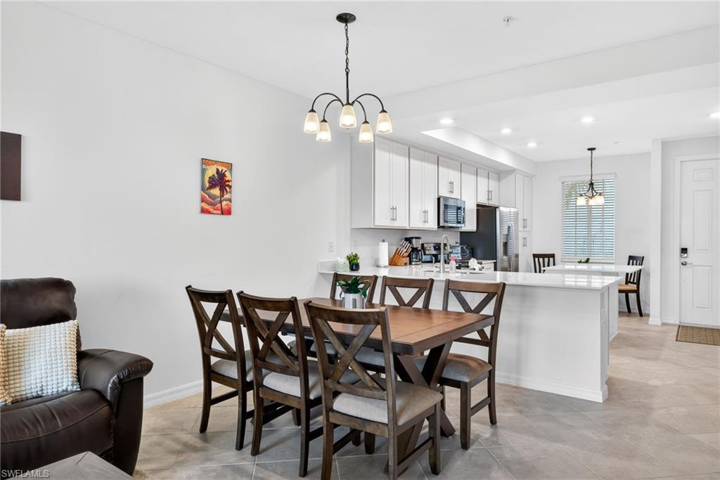 43985 Boardwalk Loop, Unit 2115 Punta Gorda, FL 33982 - Photo 6 of 28 a view of a dining room with furniture and a chandelier