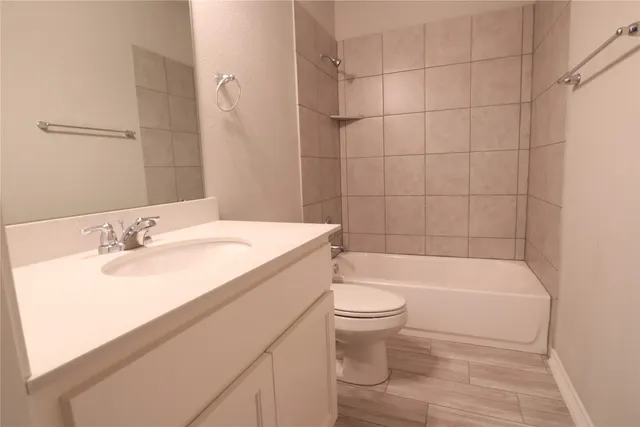 a bathroom with a sink a toilet and bathtub