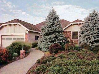 a view of a house with a small yard and plants