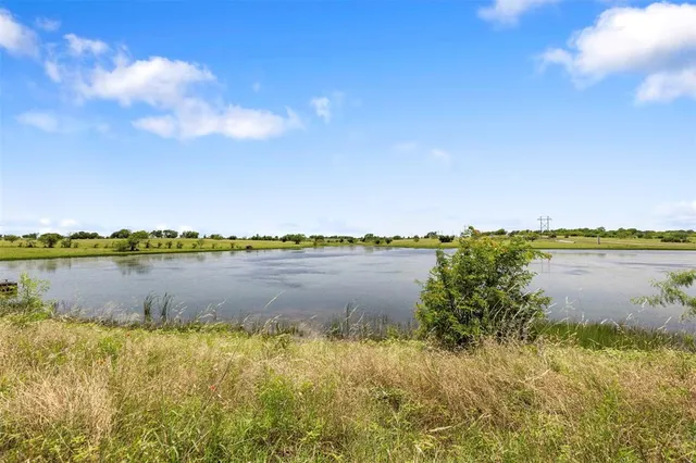 a view of a lake with a car parked in the background