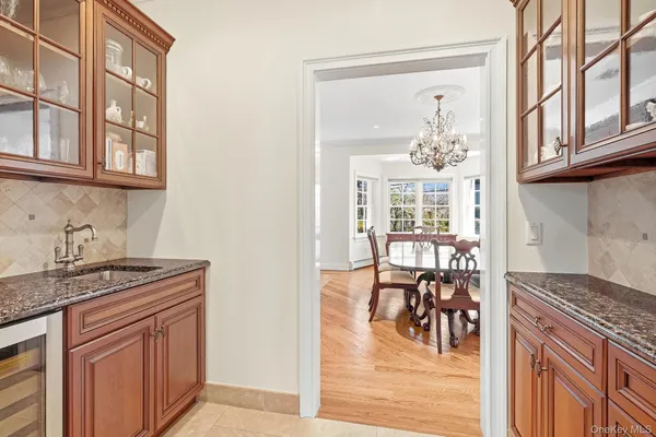 a kitchen with granite countertop a stove a table and chairs in it