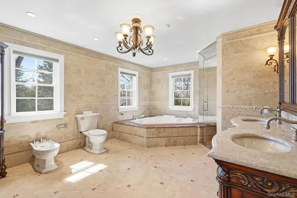 a bathroom with a granite countertop sink and a large mirror
