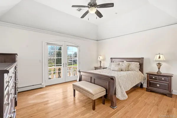 a spacious bedroom with a bed a couch and a window