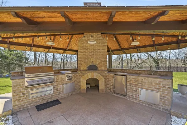 a view of a porch with a table and chairs