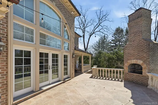 a view of a roof deck with couches and wooden floor