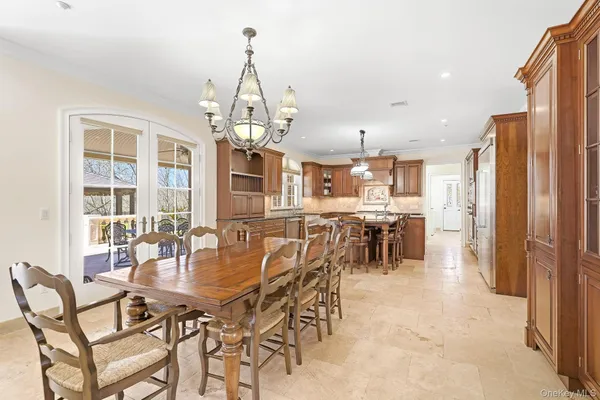 a dining room with furniture and chandelier
