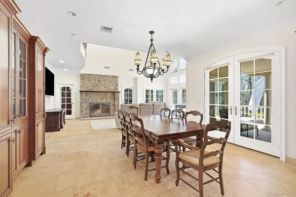 a view of a dining room with furniture and a chandelier