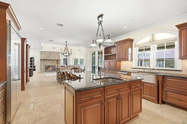 a kitchen with stainless steel appliances granite countertop a sink and a refrigerator