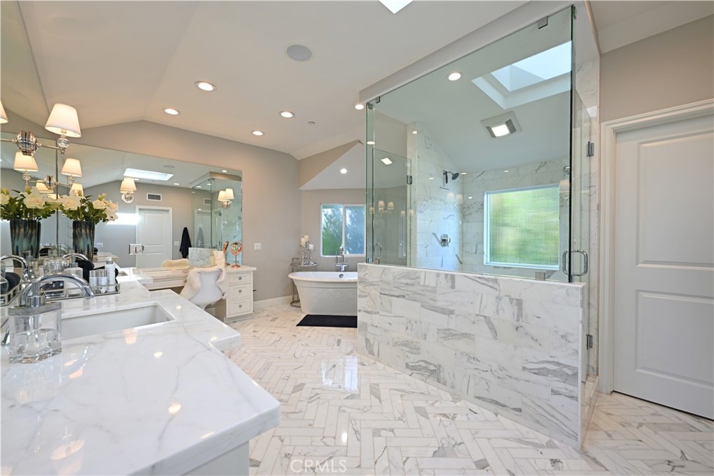 90 Marbella San Clemente, CA 92673 - Photo 17 of 39 a large white bathroom with a large mirror vanity and shower