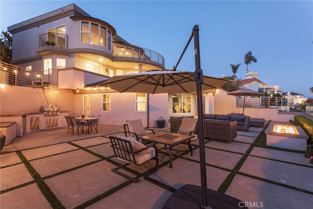 90 Marbella San Clemente, CA 92673 - Photo 34 of 39 a view of a patio with a table and chairs under an umbrella