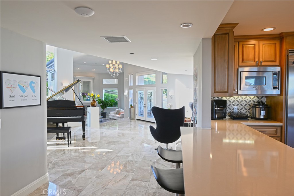 90 Marbella San Clemente, CA 92673 - Photo 9 of 39 a living room with furniture a piano and a fireplace