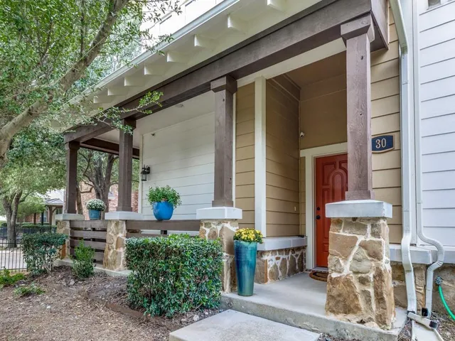 a front view of a house with a potted plant