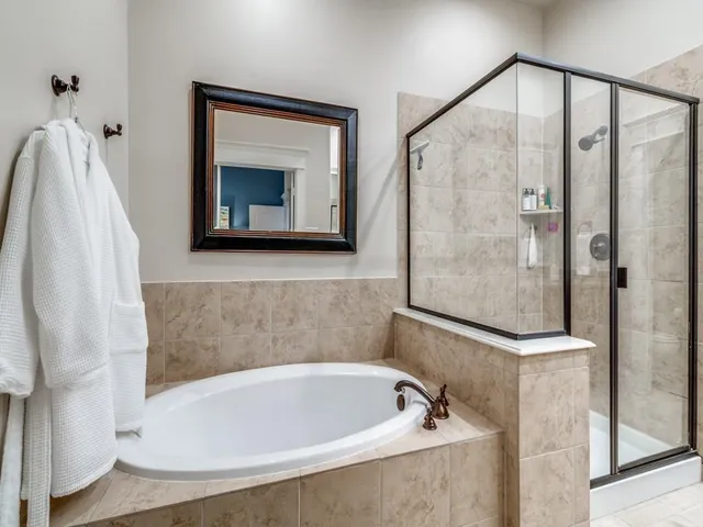 a bathroom with a bathtub and a shower