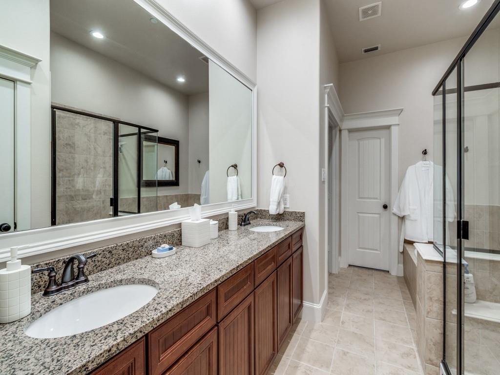 1600 Abrams Road, Unit 30 Dallas, TX 75214 - Photo 16 of 26 a bathroom with a granite countertop double vanity sink a mirror and shower