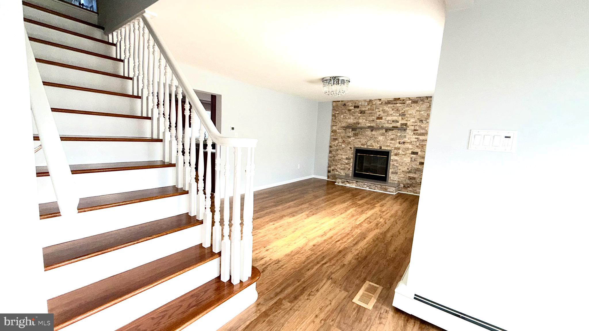 27 3rd Avenue Toms River, NJ 08757 - Photo 12 of 69 a view of a livingroom with wooden floor and fireplace