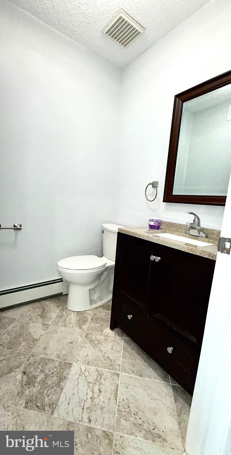 27 3rd Avenue Toms River, NJ 08757 - Photo 26 of 69 a bathroom with a toilet sink and mirror