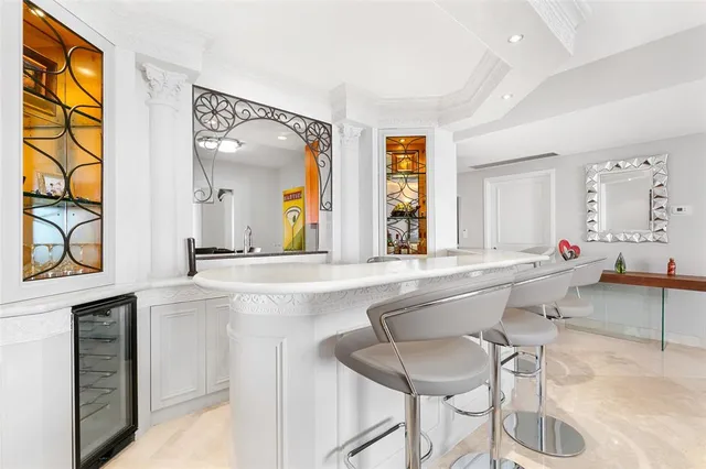 a view of a dining room with furniture and chandelier