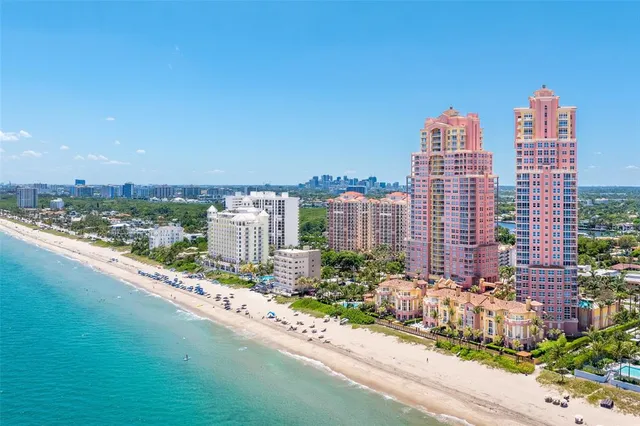 a view of a dining room with furniture and a chandelier