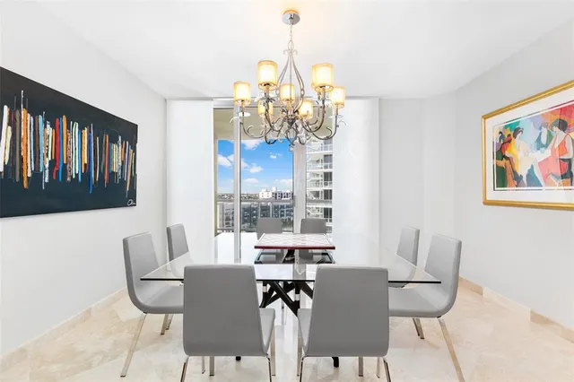 a dining room with furniture and a window