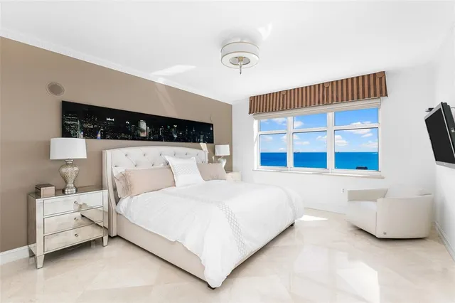 a bedroom with a large bed and a window