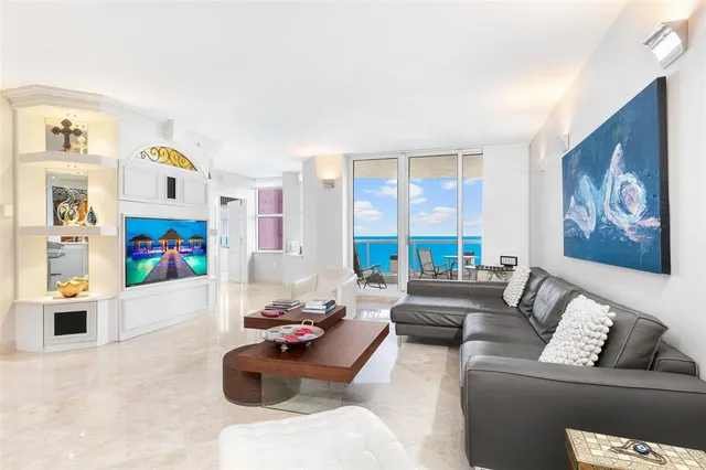 a balcony with wooden floor outdoor seating and city view