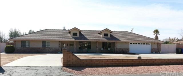 20361 Ottawa Road Apple Valley, CA 92308 - Photo 1 of 1 a front view of a house with a garden