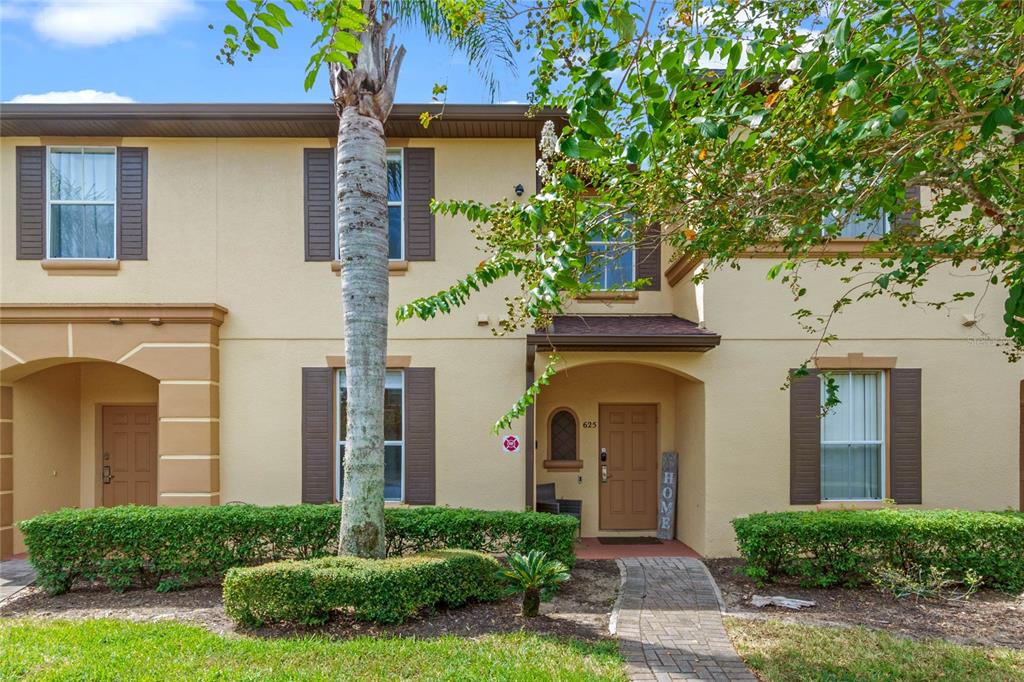 625 Terra Lago Street Davenport, FL 33897 - Photo 1 of 36 a front view of a house with garden