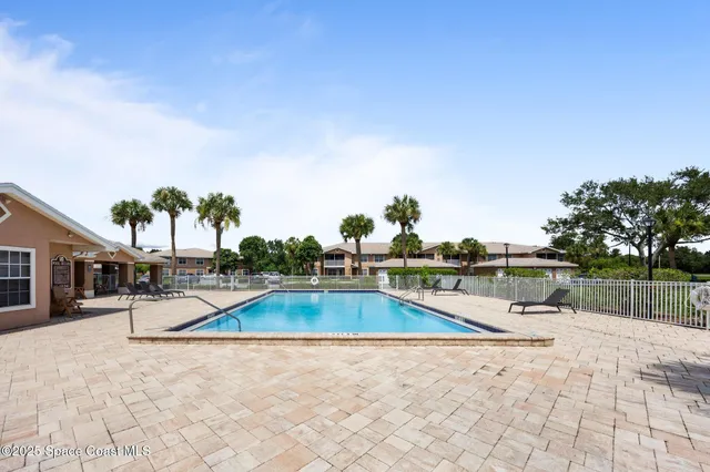 a view of a swimming pool with a lounge chair