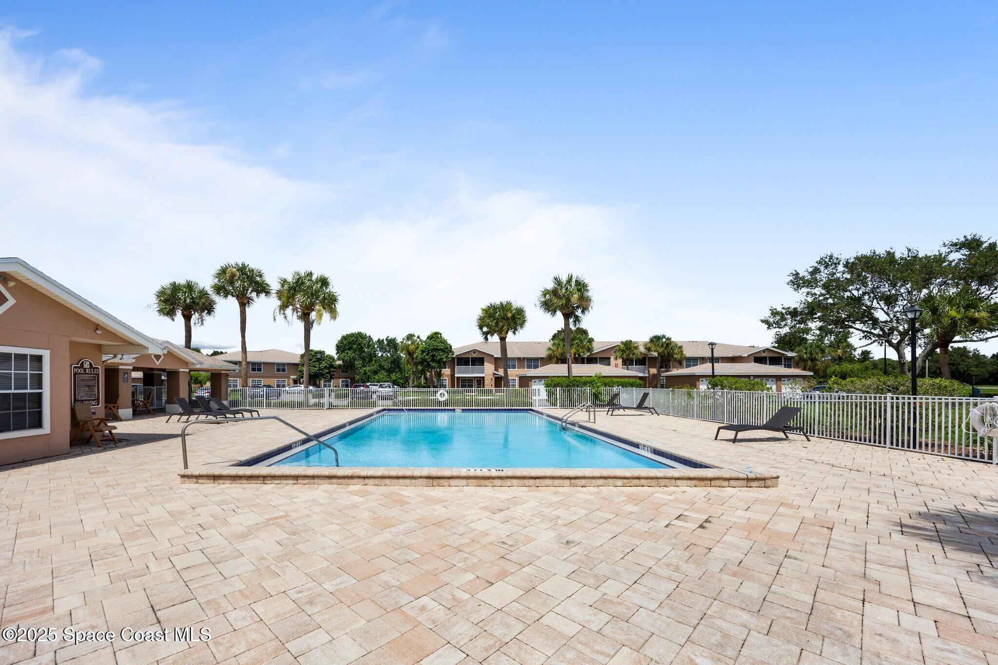 1790 Rocky Wood Circle, Unit 205 Rockledge, FL 32955 - Photo 3 of 11 a view of a swimming pool with a lounge chair