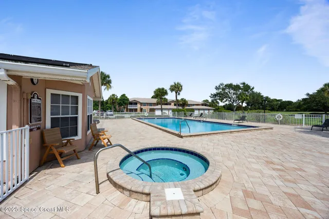 a swimming pool with outdoor seating and barbeque in the back yard