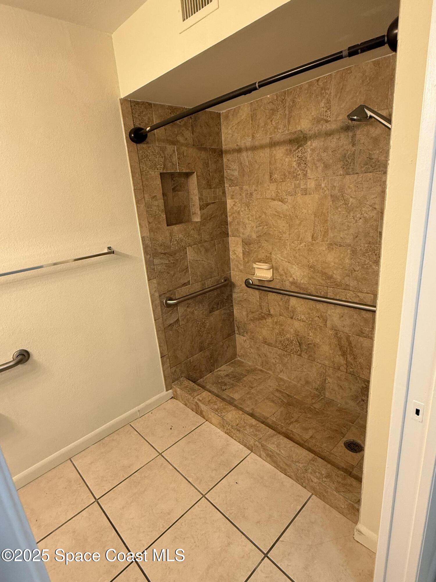 1790 Rocky Wood Circle, Unit 205 Rockledge, FL 32955 - Photo 8 of 11 a bathroom with a shower