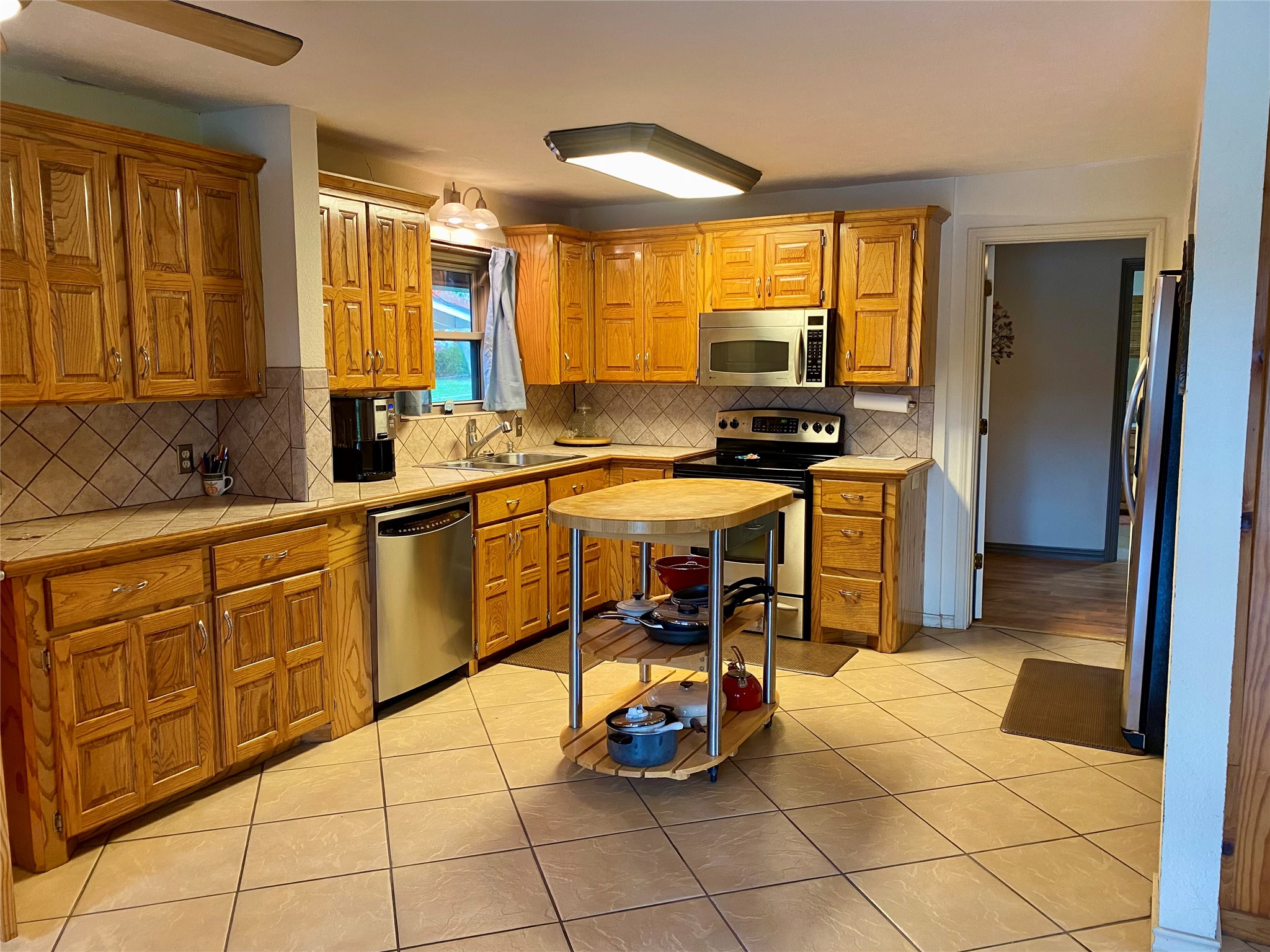 173 Ridgecrest Drive Burkeville, TX 75932 - Photo 15 of 27 a kitchen with stainless steel appliances granite countertop a sink a stove and a refrigerator