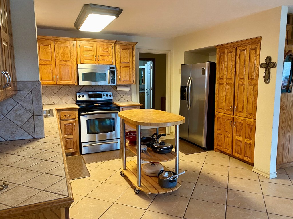 173 Ridgecrest Drive Burkeville, TX 75932 - Photo 16 of 27 a view of a kitchen with dining area and glass windows