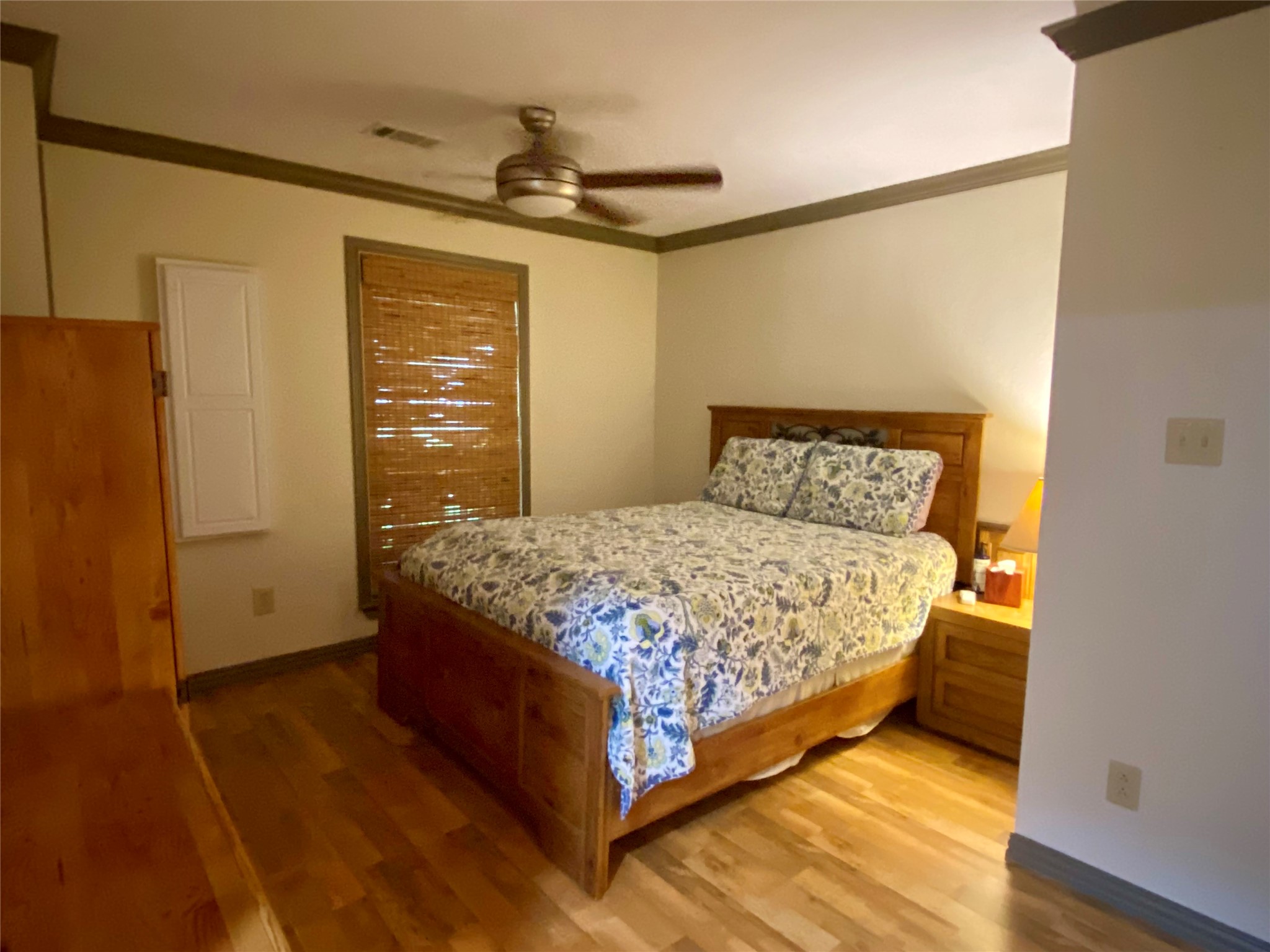 173 Ridgecrest Drive Burkeville, TX 75932 - Photo 19 of 27 a bedroom with a bed and wooden floor