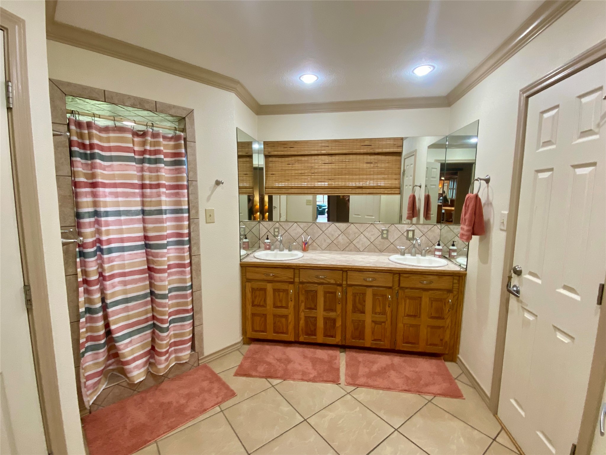 173 Ridgecrest Drive Burkeville, TX 75932 - Photo 21 of 27 a bathroom with a double vanity sink and a mirror