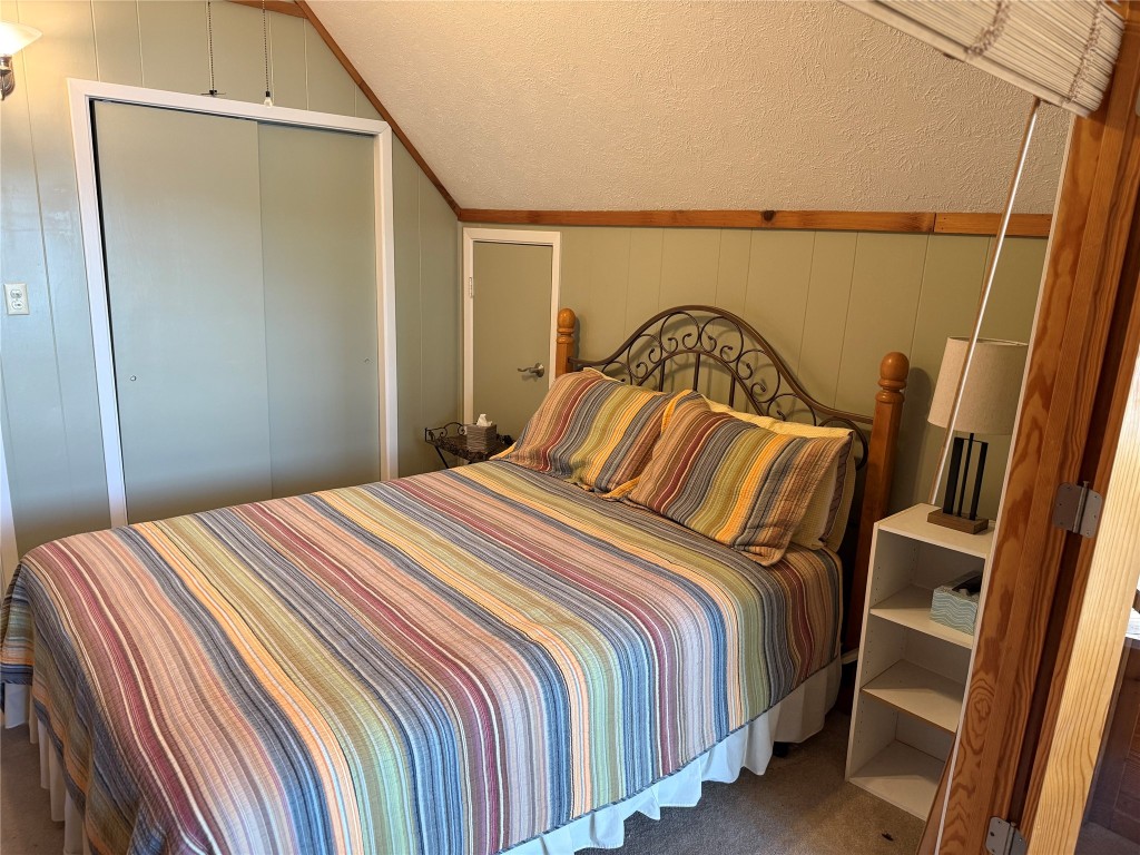 173 Ridgecrest Drive Burkeville, TX 75932 - Photo 23 of 27 a bedroom with a bed and a mirror