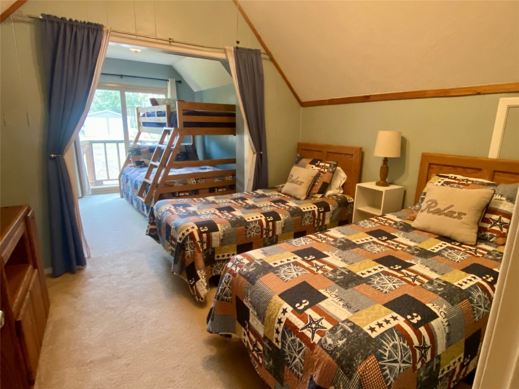 173 Ridgecrest Drive Burkeville, TX 75932 - Photo 25 of 27 a bedroom with two beds and painting on the wall