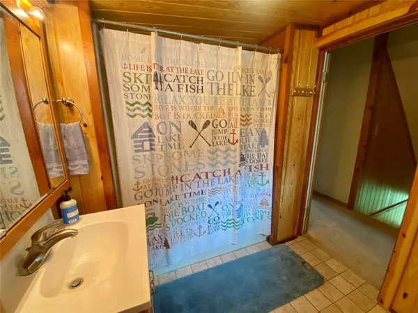 a bathroom with a toilet sink and a mirror