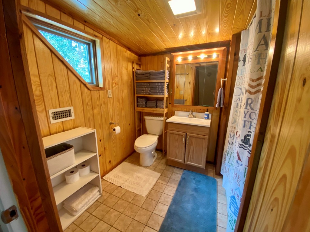 173 Ridgecrest Drive Burkeville, TX 75932 - Photo 27 of 27 a bathroom with a toilet sink and a mirror