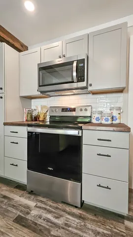 a kitchen with a stove and a microwave