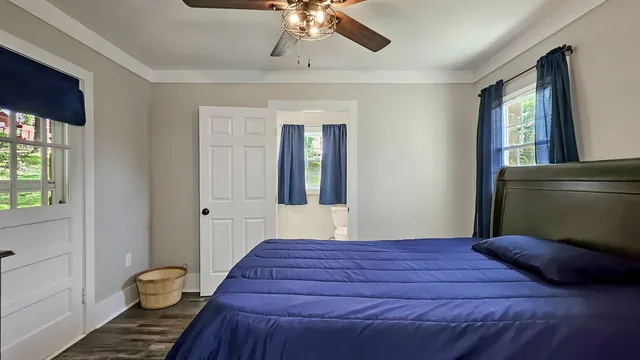 a bedroom with a large bed and a window