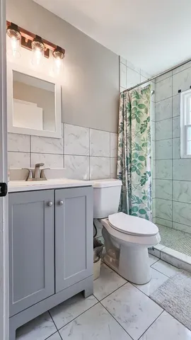 a bathroom with a sink toilet and shower