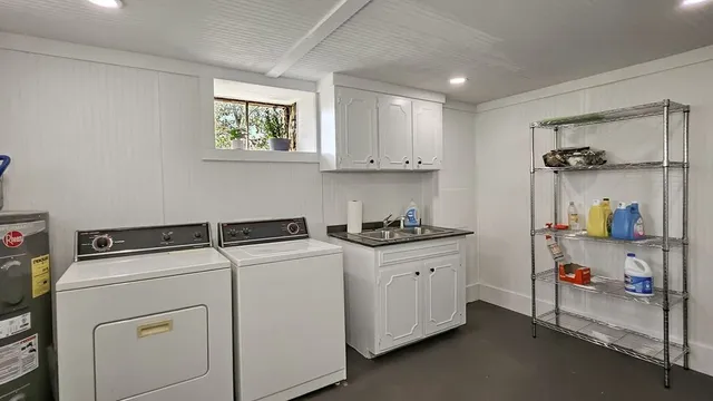 a kitchen with sink cabinets and appliances