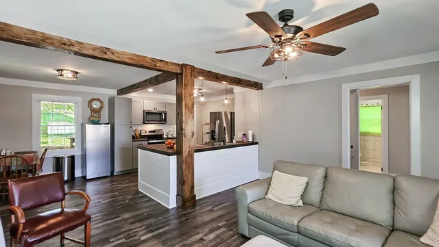 a living room with furniture and kitchen view