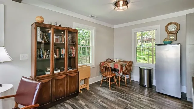 a view of a workspace with furniture and a window