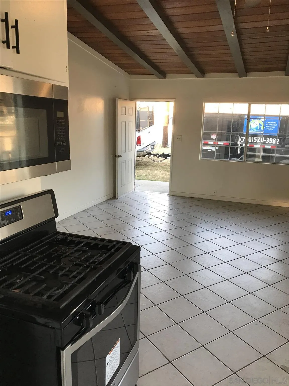 395-397 Eddie Drive Vista, CA 92083 - Photo 20 of 30 a kitchen with granite countertop a stove and a microwave