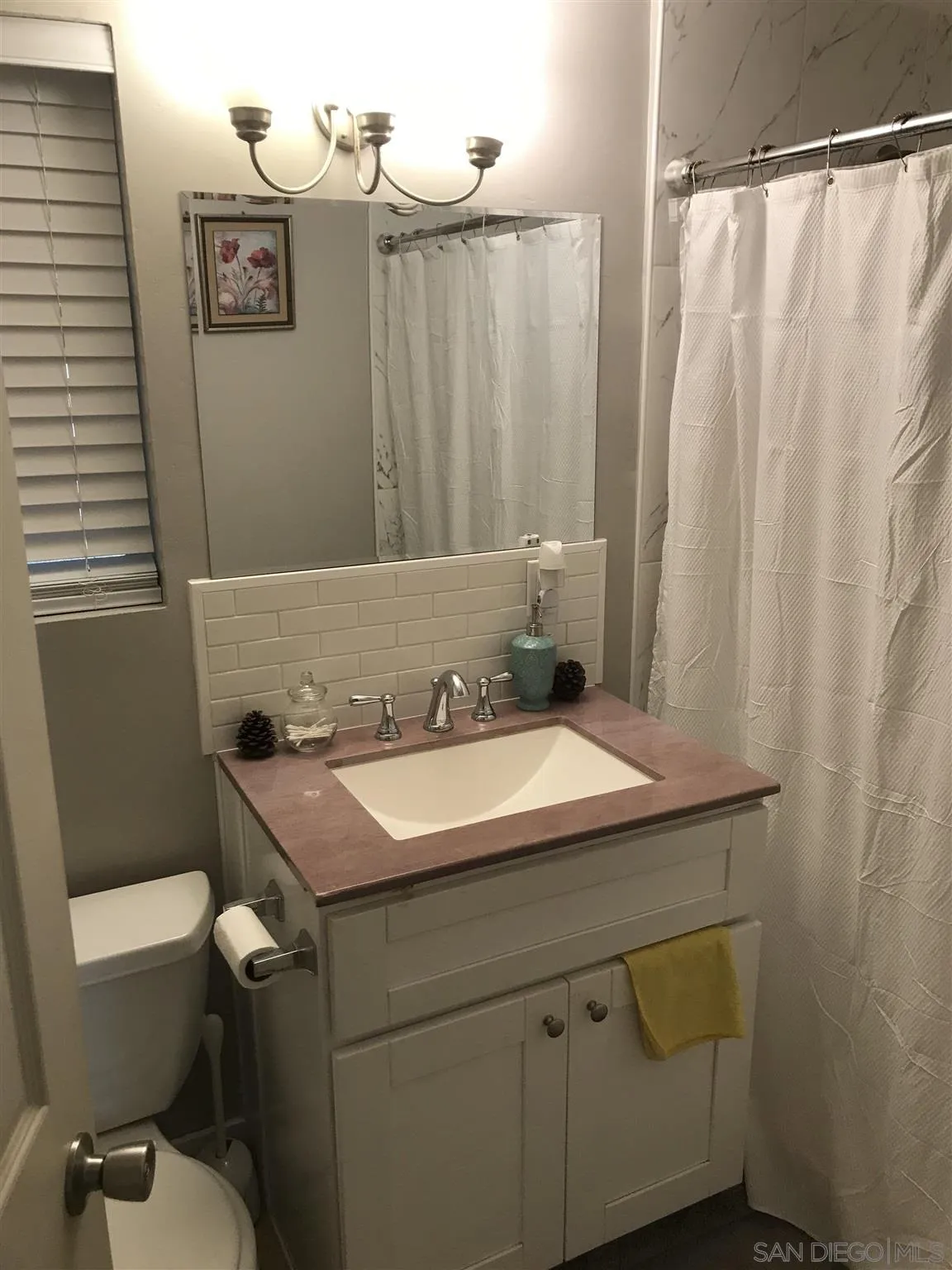 395-397 Eddie Drive Vista, CA 92083 - Photo 10 of 30 a bathroom with a granite countertop sink toilet and a shower